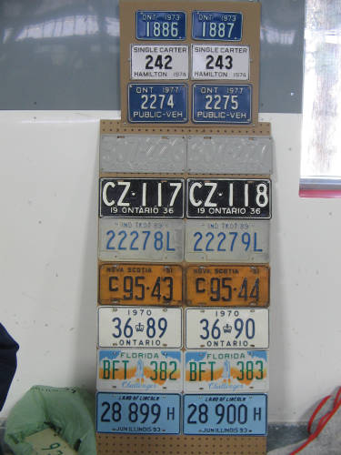 [Display of consecutively-numbered license plates]